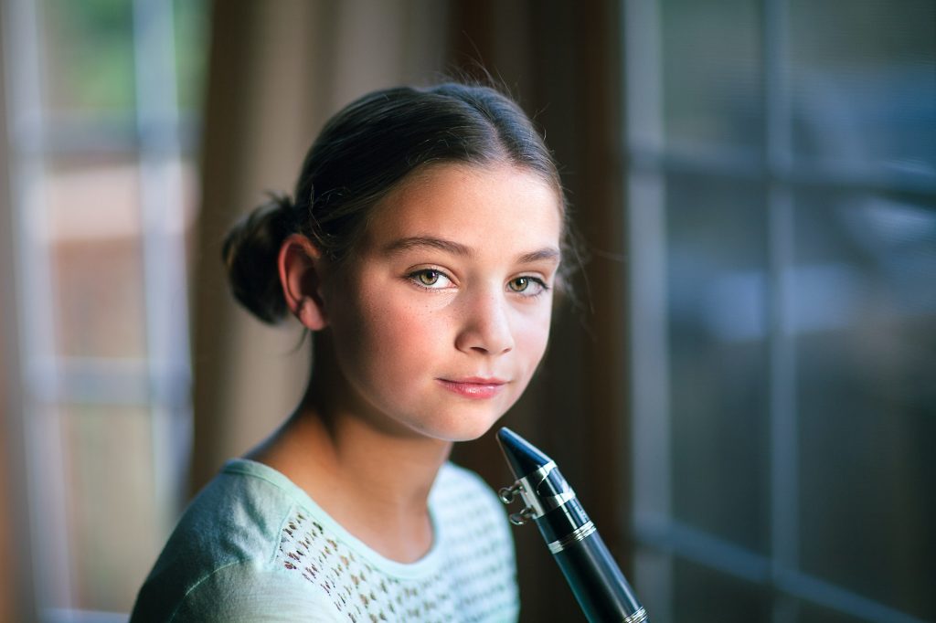 Young clarinettist posing with her clarinet