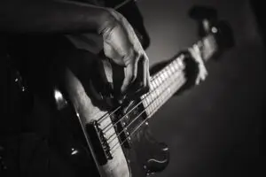 Electric bass guitar player hands, live music