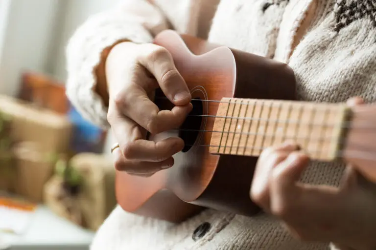 Woman's hand playing ukulele.